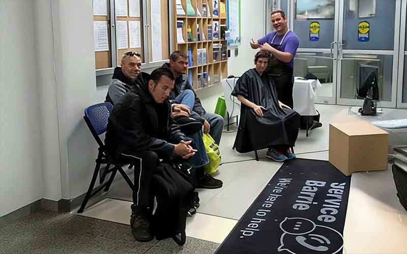 Members of the Barrie homeless community, line up for donated haircuts.
