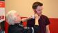 Here, volunteers are being given the Hollywood touch for our simulation . . .